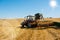 tractor equipped with a stubble cultivator in action in the cereal fields after the harvest