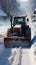 Tractor and excavator work in tandem: clearing roads and cleaning streets of snow.