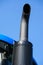 Tractor exhaust pipe. blue sky background