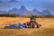 Tractor Farming Ground Harvesting Crops in Fall Autumn Teton Mountains Rugged