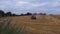 Tractor in farmland harvesting crops