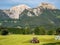 Tractor fertilizes a field in the Alps