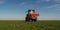 tractor fertilizing in field