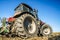 Tractor in the field. Agricultural machinery. Agricultural farm tractor during tillage of soil and field after harvest.