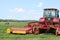 Tractor on the field, surrounded by storks