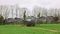 Tractor fitted with a slurry spreader extending its boom arms in a field. UK