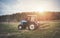 The tractor goes and pulls a plow plowing a field before landing of crops.