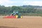 Tractor harrowing field.