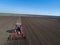 Tractor harrowing soil in spring