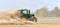 The tractor harrows the field in a huge dust cloud.