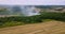 tractor harvests wheat in the field