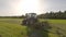 Tractor hay harvesting in a field in Bavaria, Germany August 20, 2022. in summer. Agricultural trucks mow meadow in