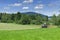 Tractor with hay tedder on a field in Bavaria