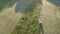 Tractor haymaking cut hay grass in evening, aerial