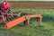 A tractor with implements mower cuts clover. Tractor mowing paddock