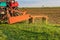 A tractor with implements mower cuts clover. Tractor mowing paddock