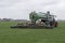 Tractor injects liquid manure in a meadow