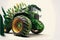 a tractor with a large tire and a green planter on the front of it\\\'s wheels, with a white background behind it, and a wh