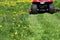 Tractor lawn mower cutting the grass in springtime