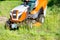 Tractor lawn mower is a powerful garden tool for the maintenance of large areas of park lawns