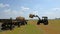 Tractor lifting hay bale