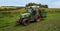 Tractor with load of boxes contain bunches of grapes at harvest time. England, UK