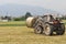 Tractor loading hay bale in Turin