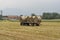 Tractor loading hay bale in Turin