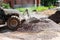 The tractor loads granite rubble into its bucket.