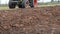 Tractor machine closeup plow trench furrow agriculture field