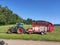 Tractor with machine collecting freshly mown grass