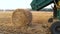 Tractor making hay bales.