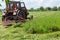 Tractor mounted rotary mower during operation on hayfield