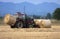 Tractor moving bales