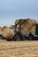 Tractor moving bales