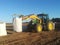 Tractor moving big bags of potatoes