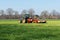 Tractor with mower-conditioner on a meadow