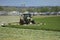 A Tractor Mowing a field