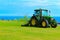 Tractor mowing grass at the Leas Folkestone UK