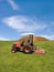 Tractor mowing green field