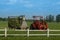 Tractor with mowing machine lawn mower at farm