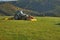 Tractor mowing mountain meadow