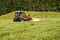 Tractor mowing Swiss alpine meadow near St. Moritz