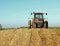 Tractor on Pile of Cornstalks