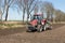 Tractor plough at bare Dutch field in early springtime