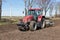 Tractor plough at bare Dutch field in early springtime