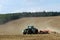 Tractor ploughing in field