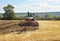 Tractor Ploughing over a field of Wheat stubble