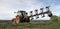 Tractor and plow under blue sky on field in luxembourgh