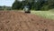 Tractor plowed autumn farm field